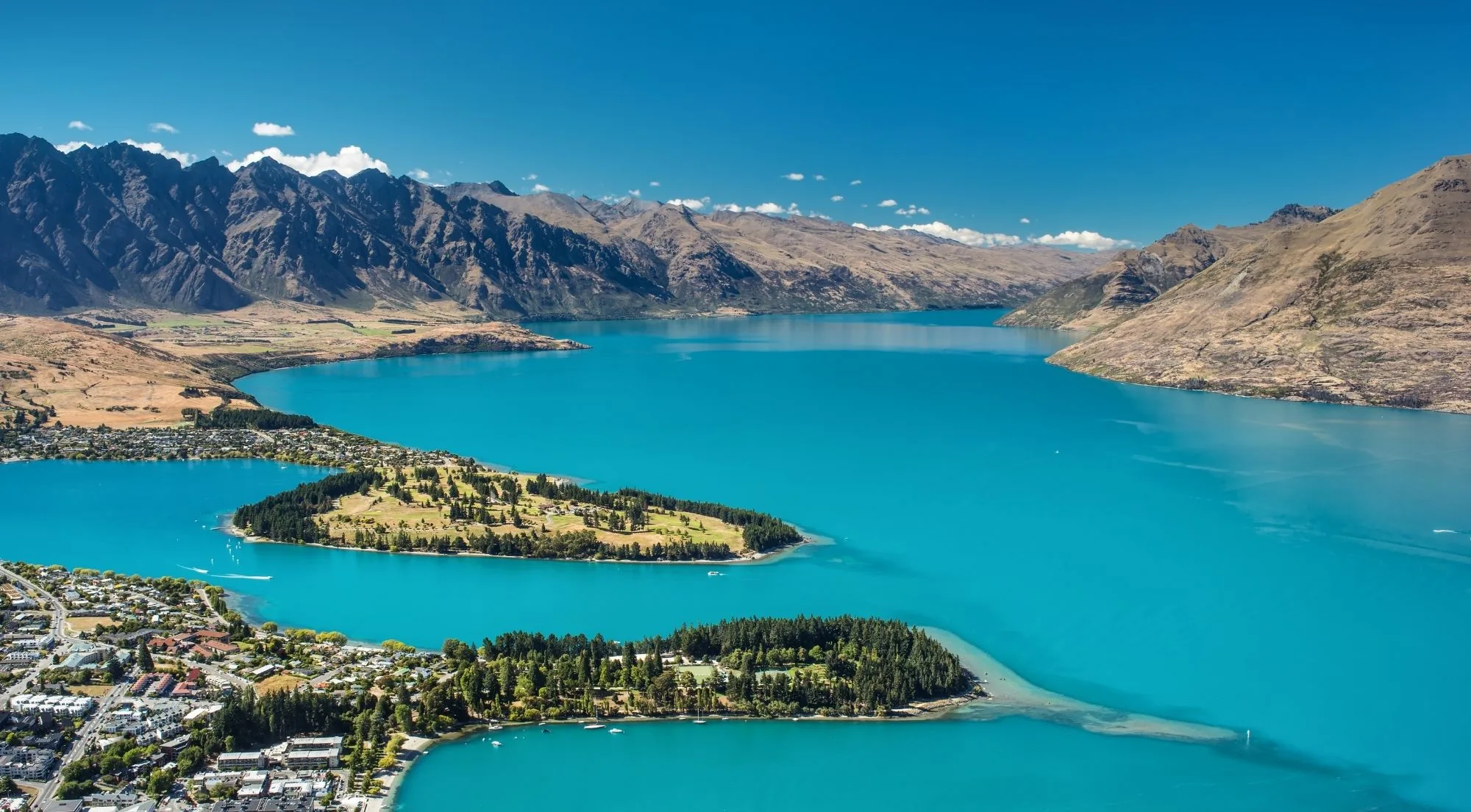 Aerial view of Queenstown on its peninsula with the Remarkables across Lake Wakatipu