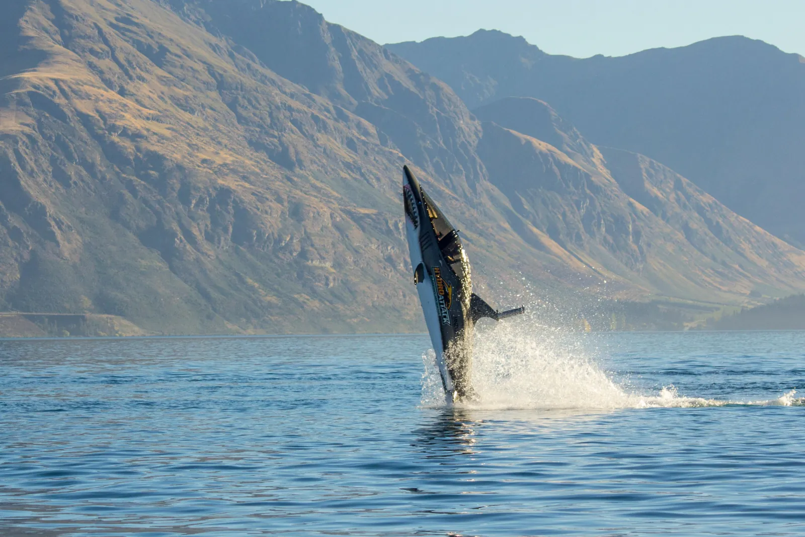 The shark-shaped Hydro Attack craft launching clear of the lake surface