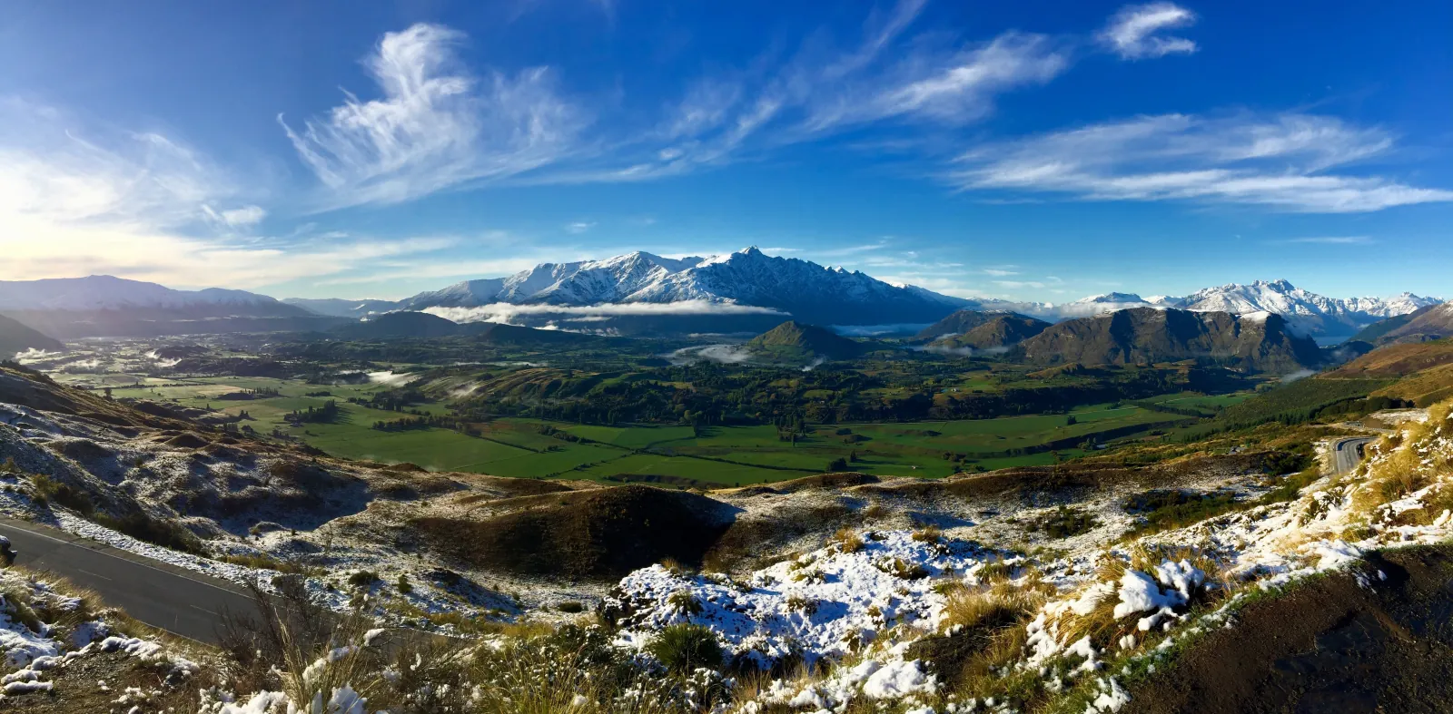 A wide view over the Shotover valley towards snow-covered ranges