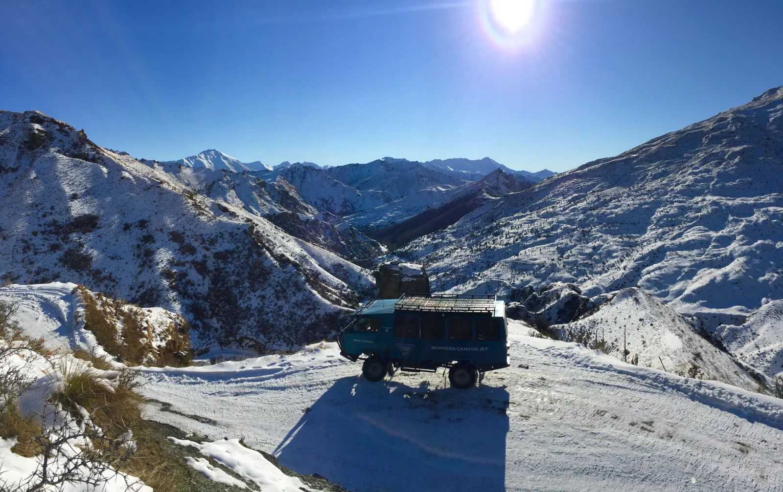 A bus on the narrow Skippers Road above the canyon in winter