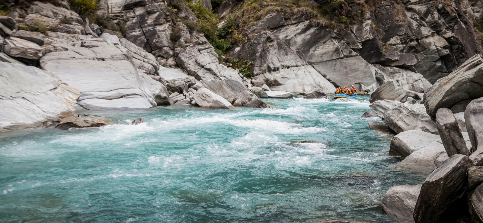 White water running fast between pale rock slabs on the Shotover