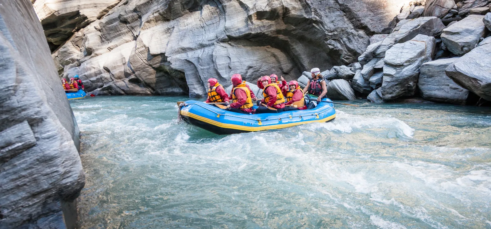 A raft working through a narrow rock-walled chute